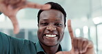 Face, happy and finger frame with a business black man in the office closeup for a photograph. Portrait, smile and measure with a young employee looking excited in his professional workplace