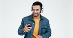 Man, headphones and face with listening, studio and dance with audio, smile or choice by white background. Happy young dancer, smartphone and mobile app for music, sound tech and streaming with click