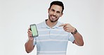 Studio, man face and hand pointing to green screen phone with mockup for sign up, promo or space on white background. Portrait, smile and model show app, review or online giveaway, contact or menu