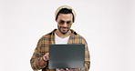 Smile, man and laptop in studio for social media, blog and editing content on white background space. Happy, networking and male fashion influencer online for faq, comment or internet, search or post