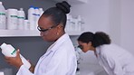 Chemicals, reading and woman scientist in a laboratory for experiment, research or study. Science, professional and young African female chemist checking liquid pharmaceutical products for inventory.