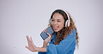 Woman, headphones or dance with smartphone, singing in studio and celebrate freedom of party on white background. Excited model dancing with energy, mobile cellphone or listening to happy radio music