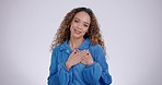 Hand on chest, woman and studio for kindness, gratitude and love or appreciation for compliment. Portrait of a happy person with gesture for thank you, empathy and peace or donation for charity