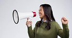 Happy asian woman, megaphone and broadcast in promotion, sale or notification against a grey studio background. Excited female person talking on loud speaker in motivation, communication or alert