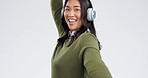 Dance, headphones and happy Asian woman on a white background for celebration, freedom and party. Happiness, dancing and portrait of isolated person listening to music, radio and audio in studio