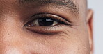 Eye, vision and zoom with portrait of black man in studio for wellness, healthcare, optometry or retina. Human, contact lens and exam with closeup of person on white background for eyeball and iris