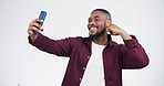 Studio, selfie and man with peace, arm flex and hand pointing to phone with smile on white background. Smartphone, profile picture and influencer model with emoji hands for social media, blog or post