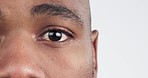 Sad, eyes and black man in studio for depression, anxiety or grief closeup on white background. Zoom, portrait and half face of scared guy worry, stress or broken heart, guilt or mental health crisis