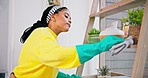 Dust cleaning, woman and home with wash cloth and cleaner in a living room. Bookcase shelf, female person and housekeeping in a lounge with furniture and maintenance for health and hygiene work