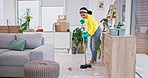 Woman, broom and dirt on living room floor for job, services and hospitality with gloves, safety or bacteria. Cleaning lady, sweeping and home for dust, paper and mess for housekeeping maintenance