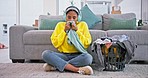 Laundry, happy and woman smell clothes with headphones for housekeeping, cleaning and washing. Home, living room and person with basket of clothing, fresh washing and fabric scent listening to music