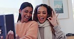Women relax together, selfie and smile in home for social media post, memory or emoji happy face. Photography, technology and girl friends in living room for profile picture, meme or content creation