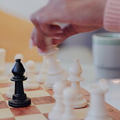 Close Up of Hands Hackers Colleagues Playing Chess Game to