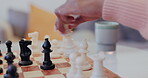 Hands, chess and people playing a strategy game in the living room of a home closeup for competition. Thinking, table and challenge with friends problem solving during a boardgame  of intelligence