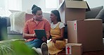 Happy couple on floor of new house with boxes, tablet and research for ideas on decor, investment and mortgage. Moving, man and woman relax in living room with online search for home renovation app.