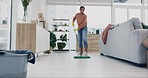 Woman, mopping or cleaning living room floor in house for hygiene, dirt or bacteria safety in housekeeping routine. Person, wipe or equipment for ground dust control, disinfection or germs protection