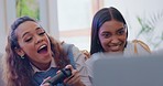 Girl friends, sofa and competition on video game, relax and esports challenge in home living room. Women, gaming and excited people on couch, lounge and contest with virtual controller in apartment