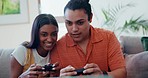 Home, smile and couple with video games, relax and playful on a weekend break, laughing and bonding. People, man and woman on a couch, entertainment or fun with console controller, crazy or challenge