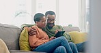 Search, internet and couple on a sofa with tablet, hug and conversation in their home together. Love, chat and black woman with man in a living room online for streaming, subscription or social media