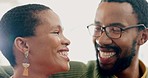 Happy, laugh and African couple on sofa for bonding, funny conversation and relax together. Embrace, healthy relationship and man and woman at home smile for humor, joke and talking for care and love