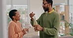 Happy African couple, champagne and home for party, goals or celebration for success, comic laugh or joke. Young black woman, man and bottle for alcohol, drink and achievement with talking in house