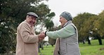 Senior couple, dancing and happy outdoor at a park with fun energy and love on holiday. Elderly man and woman in nature for a spin, funny adventure and celebration of retirement, marriage and freedom