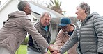 Elderly people, hands together and fitness in teamwork, motivation or support in outdoor unity at old age home. Happy senior group piling in team building, goals or mission for exercise or workout