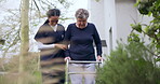 Rehabilitation, walker or nurse helping an old woman in retirement or hospital for wellness or support. Exercise, caregiver nursing or elderly patient learning mobility with walking frame in garden 