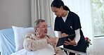 Tablet, healthcare and a nurse with a patient in the hospital to explain results or diagnosis during consulting. Medical, support and data with a female medicine professional talking to a senior an