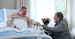 Old man in bed laughing, woman and hospital visit with support, hope and trust in healthcare, happiness and conversation. Elderly couple, nursing home and comic love with wellness in senior care.