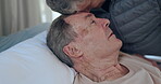 Sick, face and senior people, man or patient ill from cancer, medical problem or old age disease on hospital bed. Forehead touch, support care and elderly person with infection, crisis or virus