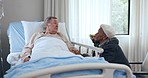 Old man in bed, woman and hospital visit, support with care and trust in healthcare, kindness and conversation. Elderly couple, nursing home and love in sickness, wellness and marriage in retirement.