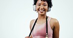 Skipping rope, fitness and woman with headphones on a white background for workout, training and exercise. Happy, sports and portrait of person listening to music, radio and audio in studio for jump