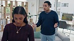 Divorce, conflict and couple fight in living room with stress, abuse or depression at home. Marriage, crisis and angry man argue with woman with headache, anxiety or fear, ignore or drama dispute