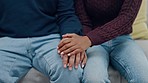 Love, trust and couple on a sofa holding hands in support of mental health, criss and empathy in their home. Depression, hope and people in living room for comfort, sorry and kindness for infertility