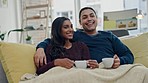 Smile, coffee and couple watching a movie on a sofa in the living room for relaxing together. Conversation, laugh and young man and woman drinking cappuccino and streaming show, film or video at home