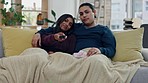 Remote, relax and couple watching a movie on sofa in the living room for relaxing together. Conversation, happy and young man and woman streaming show, film or video in the lounge of their apartment.