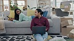 Technology, smile and internet with a couple on a sofa in the living room of their home together for social media. Laptop, tablet or website with a young man and woman in their apartment to relax