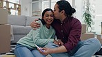 Excited, couple kiss and pregnancy test in new home, bonding or interracial celebration in living room. Pregnant, happy man and woman in house for success in results of baby, property and real estate