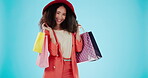 Product, shopping bag and dance with face of woman in studio for boutique, retail and wardrobe. Fashion, choice and luxury with portrait of customer on blue background for promotion, gift and sales