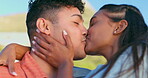 Kissing, hugging and laughing with a couple on the beach together for summer vacation or holiday closeup. Face, smile or funny with a young man and woman outdoor in nature for travel or getaway