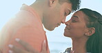 Love, smile and kiss with couple at beach for summer vacation, travel and bonding. Happy, holiday and relax with Indian man and woman on seaside date for freedom, romance and honeymoon together