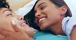 Love, smile and couple in bed with happy, conversation and relax while bonding in their home together. Smile, face and man with woman in bedroom speaking, rest and having fun on a weekend in a house