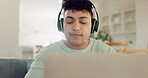 Happy, music and relax with man on sofa for freedom, streaming and social media. Dance, online radio and technology with person listening to headphones in living room at home for audio and sound