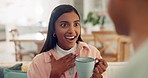 Gossip, coffee and couple talking on a sofa in the living room relaxing and bonding together. Happy, surprise and young woman speaking to her boyfriend and drinking a latte in the lounge at home.