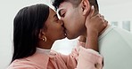 Face, couple and kiss in home with smile for love, care and commitment to intimate relationship. Young man, woman and kissing happy partner for romance, loyalty and anniversary date on valentines day