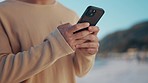 Nature, phone and closeup of hands typing a text message on social media, mobile app or website. Technology, online and man scroll on internet with cellphone for communication outdoor for travel.