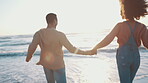 Couple, holding hands and running to ocean, beach and back view with travel, love and energy on date or honeymoon. People outdoor, tropical holiday and support, trust and commitment, partner and care