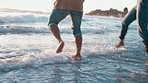 Running, legs and a couple at the beach for a vacation, summer travel or fun in the water. Playful, together and feet of a man and woman at the sea or in the ocean for playing, bonding or on a date