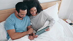 Tablet, video and laughing with a couple in bed together in the morning to relax in their home. Technology, social media or app with a man and woman watching a movie in the bedroom of their apartment